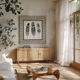 Geo Feathers Square IV by Sara Zieve Miller. Shown in a natural wood frame in a cozy modern living room. Available as an archival giclee rolled canvas, fine art paper, or poster print. SKU 18708a.