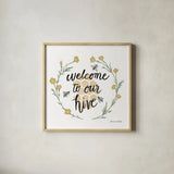 Happy to Bee Home III Welcome by Sara Zieve Miller. Shown in a natural wood glass frame for a timeless modern aesthetic. Available as an archival giclee rolled canvas, fine art paper, or poster print. SKU 44544a.