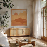 Mountainous II Orange by Sara Zieve Miller. Shown in a natural wood frame in a cozy modern living room. Available as an archival giclee rolled canvas, fine art paper, or poster print. SKU 70262a.