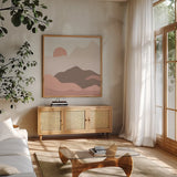 Mountainous II Pink by Sara Zieve Miller. Shown in a natural wood frame in a cozy modern living room. Available as an archival giclee rolled canvas, fine art paper, or poster print. SKU 67071a.