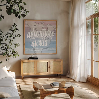 World Traveler  Adventure Awaits by Sara Zieve Miller. Shown in a natural wood frame in a cozy modern living room. Available as an archival giclee rolled canvas, fine art paper, or poster print. SKU 27427a.