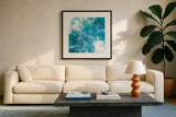 Blue Lagoon II by Sarah Adams. Displayed in a glass frame with matte in a clean modern living room. Available as an archival giclee rolled canvas, fine art paper, or poster print. SKU 90497a.