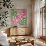 Monstera II Hot Pink by Sarah Adams. Shown in a natural wood frame in a cozy modern living room. Available as an archival giclee rolled canvas, fine art paper, or poster print. SKU 55313a.