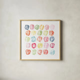 Watercolor Alphabet by Sarah Adams. Shown in a natural wood glass frame for a timeless modern aesthetic. Available as an archival giclee rolled canvas, fine art paper, or poster print. SKU 33404a.