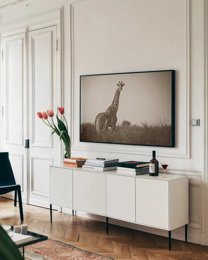 Giraffe and Baby Sepia by Sharon Vardy. shown as a framed stretched canvas in a living room above a console. Available as a archival giclee rolled canvas, fine art paper, or poster print. SKU 93123i.