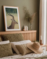 Impala Ram II by Sharon Vardy. shown as a paper print in a natural frame. Available as a archival giclee rolled canvas, fine art paper, or poster print. SKU 93126h.