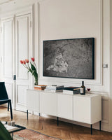 Playful Lions BW by Sharon Vardy. shown as a framed stretched canvas in a living room above a console. Available as a archival giclee rolled canvas, fine art paper, or poster print. SKU 91992i.