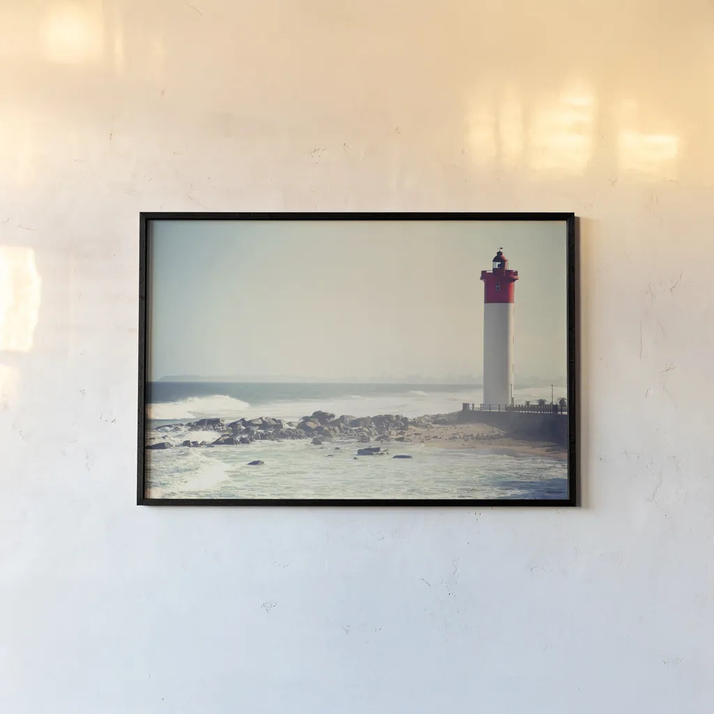 Umhlanga Lighthouse by Sharon Vardy. shown as a paper print in a black flame. Available as a archival giclee rolled canvas, fine art paper, or poster print. SKU 93121i.