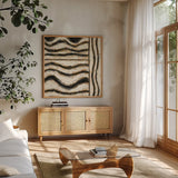 Black and Gold Geometric VI by Shirley Novak. Shown in a natural wood frame in a cozy modern living room. Available as an archival giclee rolled canvas, fine art paper, or poster print. SKU 25032a.