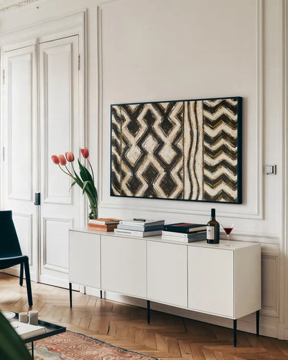 Black and Gold Geometric VII Crop by Shirley Novak. shown as a framed stretched canvas in a living room above a console. Available as a archival giclee rolled canvas, fine art paper, or poster print. SKU 25033i.