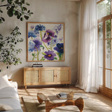 Blue and Purple Mixed Garden I by Shirley Novak. Shown in a natural wood frame in a cozy modern living room. Available as an archival giclee rolled canvas, fine art paper, or poster print. SKU 14584a.