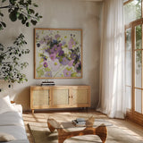 Gardening in Mauve by Shirley Novak. Shown in a natural wood frame in a cozy modern living room. Available as an archival giclee rolled canvas, fine art paper, or poster print. SKU 98489a.
