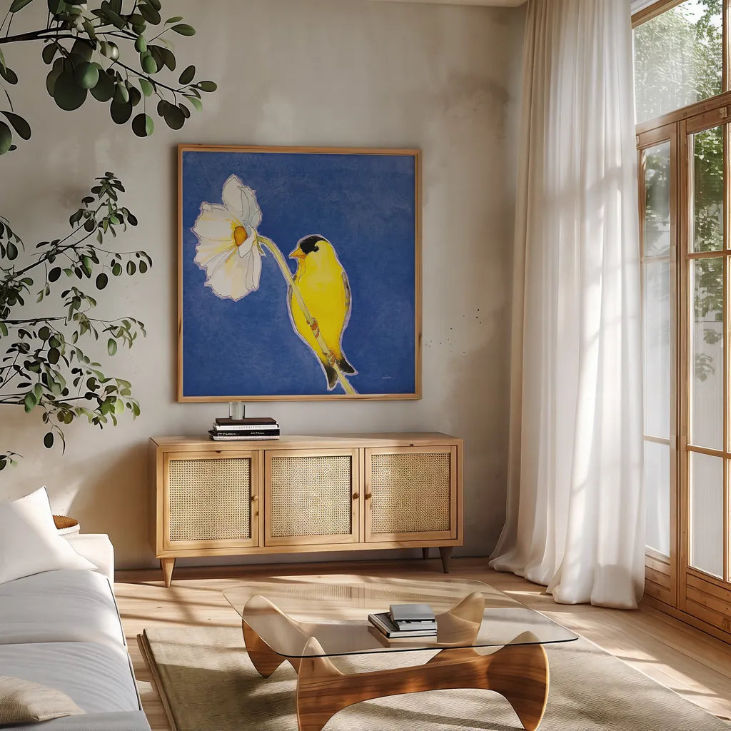 Gold Finch on White Cosmos by Shirley Novak. Shown in a natural wood frame in a cozy modern living room. Available as an archival giclee rolled canvas, fine art paper, or poster print. SKU 88681a.