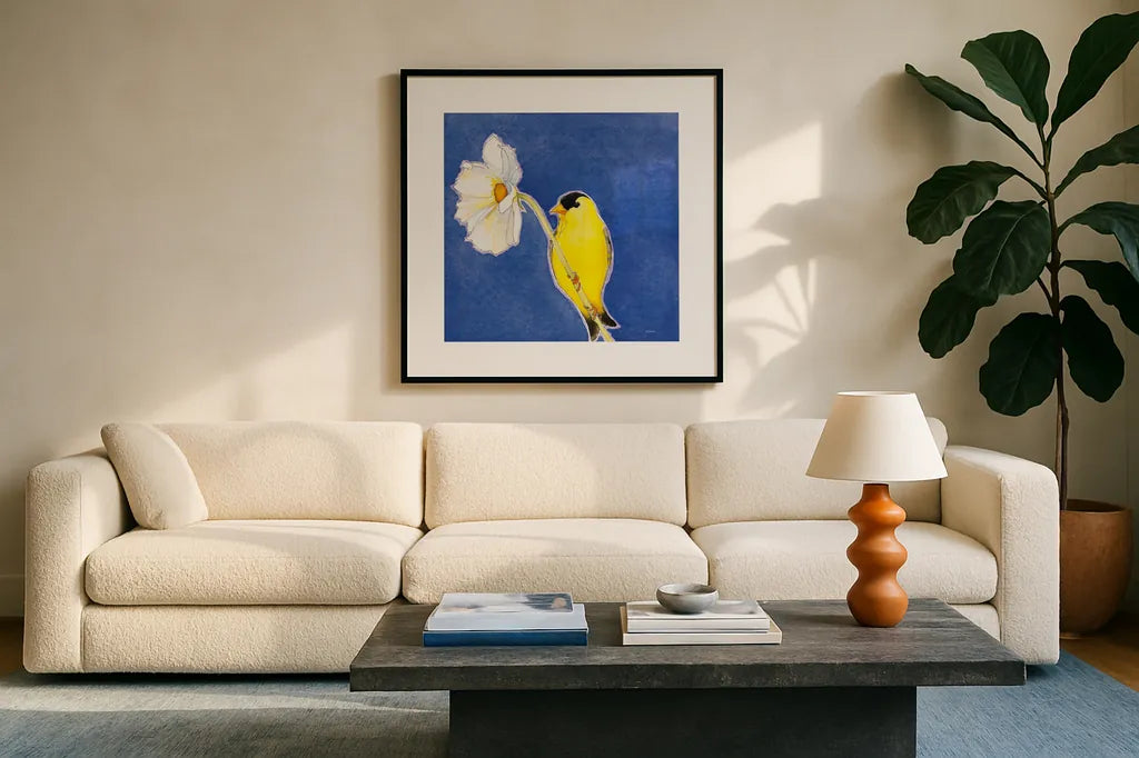 Gold Finch on White Cosmos by Shirley Novak. Displayed in a glass frame with matte in a clean modern living room. Available as an archival giclee rolled canvas, fine art paper, or poster print. SKU 88681a.