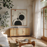 Planetary III with Red by Shirley Novak. Shown in a natural wood frame in a cozy modern living room. Available as an archival giclee rolled canvas, fine art paper, or poster print. SKU 30935a.