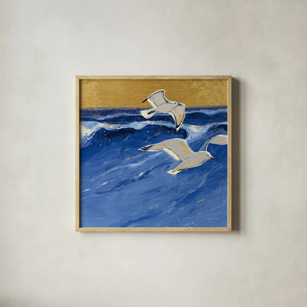 Seagulls with Gold Sky III by Shirley Novak. Shown in a natural wood glass frame for a timeless modern aesthetic. Available as an archival giclee rolled canvas, fine art paper, or poster print. SKU 25258a.