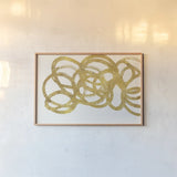Swirling Element I Crop I Gold by Shirley Novak. shown as a paper print in a natural frame. Available as a archival giclee rolled canvas, fine art paper, or poster print. SKU 68389i.