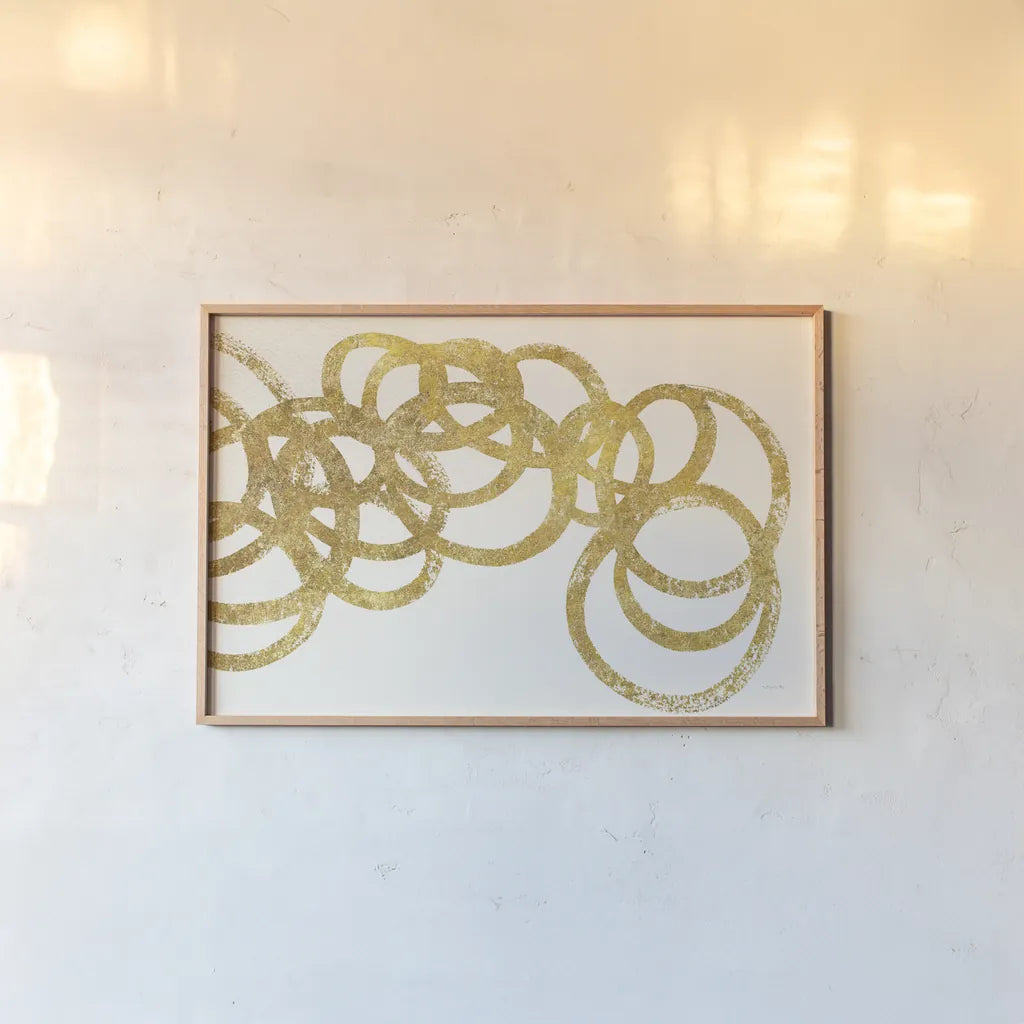 Swirling Element I Crop II Gold by Shirley Novak. shown as a paper print in a natural frame. Available as a archival giclee rolled canvas, fine art paper, or poster print. SKU 68390i.