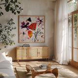 The Black Poppy by Shirley Novak. Shown in a natural wood frame in a cozy modern living room. Available as an archival giclee rolled canvas, fine art paper, or poster print. SKU 89491a.