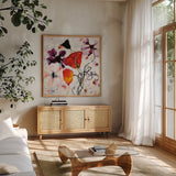 The Black Poppy by Shirley Novak. Shown in a natural wood frame in a cozy modern living room. Available as an archival giclee rolled canvas, fine art paper, or poster print. SKU 93005a.