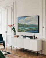 Blue Coastal Flowers by Silvia Vassileva. shown as a framed stretched canvas in a living room above a console. Available as a archival giclee rolled canvas, fine art paper, or poster print. SKU 82621i.