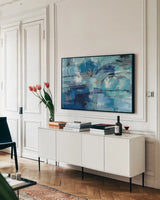 Blue Ultramarine Waves by Silvia Vassileva. shown as a framed stretched canvas in a living room above a console. Available as a archival giclee rolled canvas, fine art paper, or poster print. SKU 73954i.
