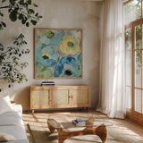 Fresh Teal Flowers II by Silvia Vassileva. Shown in a natural wood frame in a cozy modern living room. Available as an archival giclee rolled canvas, fine art paper, or poster print. SKU 34422a.