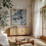 In the Clouds Indigo and Gray Crop by Silvia Vassileva. Shown in a natural wood frame in a cozy modern living room. Available as an archival giclee rolled canvas, fine art paper, or poster print. SKU 20867a.