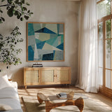 Indigo Geo Metric by Silvia Vassileva. Shown in a natural wood frame in a cozy modern living room. Available as an archival giclee rolled canvas, fine art paper, or poster print. SKU 23834a.
