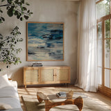 Indigo Wave by Silvia Vassileva. Shown in a natural wood frame in a cozy modern living room. Available as an archival giclee rolled canvas, fine art paper, or poster print. SKU 21582a.