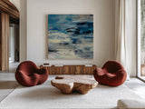 Indigo Wave by Silvia Vassileva. Shown as extra-large giant wall art in a modern living room. Available as an archival giclee rolled canvas, fine art paper, or poster print. SKU 21582a.