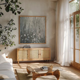 January Branches Gray by Silvia Vassileva. Shown in a natural wood frame in a cozy modern living room. Available as an archival giclee rolled canvas, fine art paper, or poster print. SKU 59629a.
