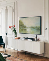 Lakeside Fog Sage by Silvia Vassileva. shown as a framed stretched canvas in a living room above a console. Available as a archival giclee rolled canvas, fine art paper, or poster print. SKU 70714i.