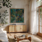 Midnight Tropical Leaves by Silvia Vassileva. Shown in a natural wood frame in a cozy modern living room. Available as an archival giclee rolled canvas, fine art paper, or poster print. SKU 67913a.