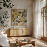 Neutral Floral Beige II Yellow Flowers by Silvia Vassileva. Shown in a natural wood frame in a cozy modern living room. Available as an archival giclee rolled canvas, fine art paper, or poster print. SKU 28406a.