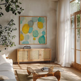 Painted Pebbles II by Silvia Vassileva. Shown in a natural wood frame in a cozy modern living room. Available as an archival giclee rolled canvas, fine art paper, or poster print. SKU 22334a.