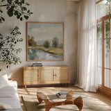 River and Clouds III by Silvia Vassileva. Shown in a natural wood frame in a cozy modern living room. Available as an archival giclee rolled canvas, fine art paper, or poster print. SKU 86032a.