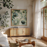 Sage and Neutral Peonies II by Silvia Vassileva. Shown in a natural wood frame in a cozy modern living room. Available as an archival giclee rolled canvas, fine art paper, or poster print. SKU 49783a.