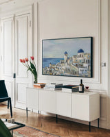 Santorini View I by Silvia Vassileva. shown as a framed stretched canvas in a living room above a console. Available as a archival giclee rolled canvas, fine art paper, or poster print. SKU 67909i.