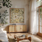 Scattered Spring Petals Neutral Gray Crop by Silvia Vassileva. Shown in a natural wood frame in a cozy modern living room. Available as an archival giclee rolled canvas, fine art paper, or poster print. SKU 49536a.