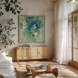 Spring Aroma II White Flowers by Silvia Vassileva. Shown in a natural wood frame in a cozy modern living room. Available as an archival giclee rolled canvas, fine art paper, or poster print. SKU 23198a.
