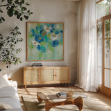Spring Aroma III White Flowers by Silvia Vassileva. Shown in a natural wood frame in a cozy modern living room. Available as an archival giclee rolled canvas, fine art paper, or poster print. SKU 23199a.