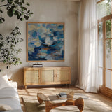 Ultramarine Waves I by Silvia Vassileva. Shown in a natural wood frame in a cozy modern living room. Available as an archival giclee rolled canvas, fine art paper, or poster print. SKU 24574a.