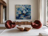 Ultramarine Waves I by Silvia Vassileva. Shown as extra-large giant wall art in a modern living room. Available as an archival giclee rolled canvas, fine art paper, or poster print. SKU 24574a.