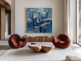 Ultramarine Waves II by Silvia Vassileva. Shown as extra-large giant wall art in a modern living room. Available as an archival giclee rolled canvas, fine art paper, or poster print. SKU 24575a.