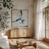 White and Blue by Silvia Vassileva. Shown in a natural wood frame in a cozy modern living room. Available as an archival giclee rolled canvas, fine art paper, or poster print. SKU 26345a.