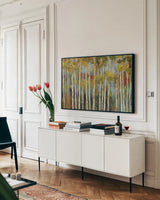 Young Forest III by Silvia Vassileva. shown as a framed stretched canvas in a living room above a console. Available as a archival giclee rolled canvas, fine art paper, or poster print. SKU 17838i.