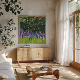 A Year of Lupines by Sue Schlabach. Shown in a natural wood frame in a cozy modern living room. Available as an archival giclee rolled canvas, fine art paper, or poster print. SKU 88563a.