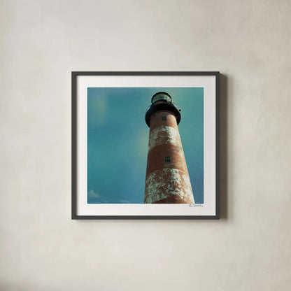 Atlantic Lighthouse by Sue Schlabach. Shown in a sleek black glass frame for a contemporary gallery look. Available as an archival giclee rolled canvas, fine art paper, or poster print. SKU 25828a.