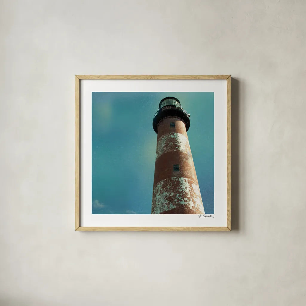 Atlantic Lighthouse by Sue Schlabach. Shown in a natural wood glass frame for a timeless modern aesthetic. Available as an archival giclee rolled canvas, fine art paper, or poster print. SKU 25828a.